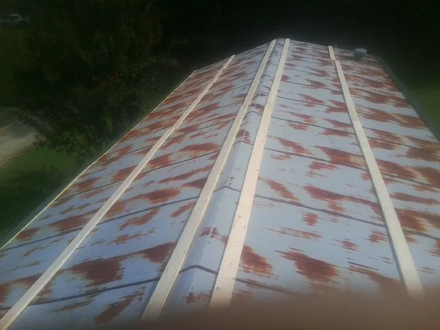 Rusted metal roof panels with new wood purlins before replacement — Storm Damage Roof Repair in Mc Henry by Roofing Brothers